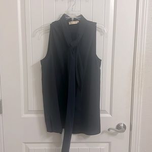Sleeveless navy top with bow